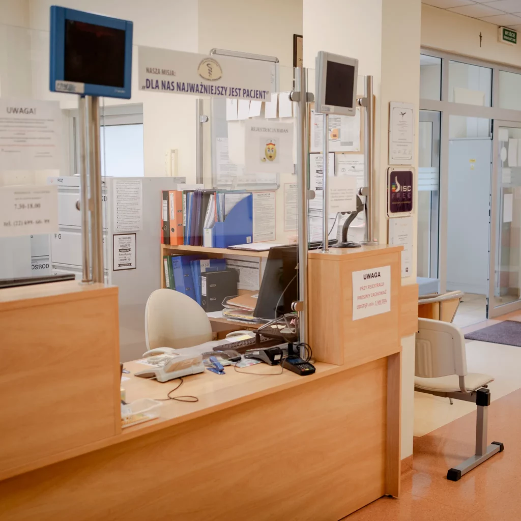 Rejestracja pacjentów w przychodni z biurkiem i komputerem